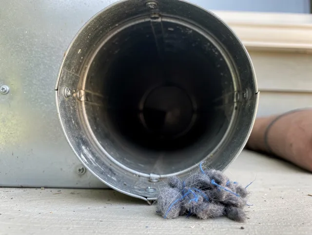 Hialeah Dryer Vent Cleaning technician using specialized equipment to clear severe dryer vent blockage in Hialeah